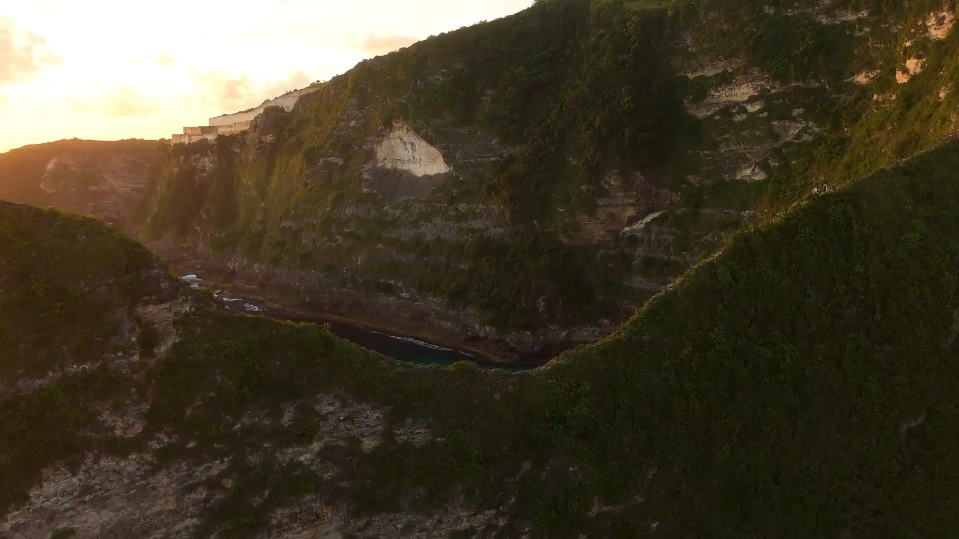 Limestone cliffs and a turquoise cove on Bali’s southern coast at sunset