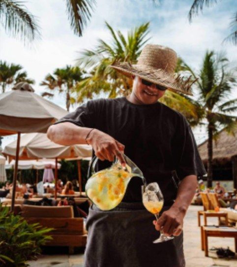 Bartender pouring a cocktail at a beach club